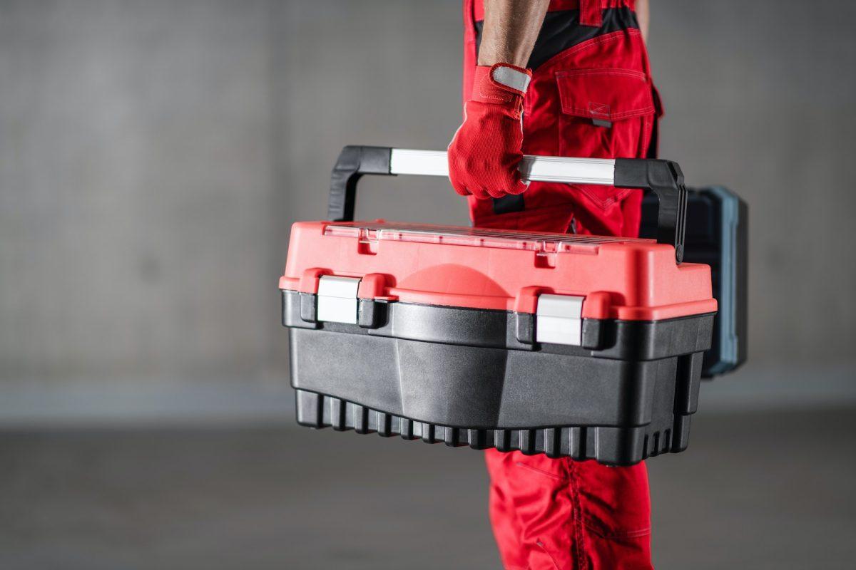 Repairman Home Call Concept with Handyman Holding His Toolbox.